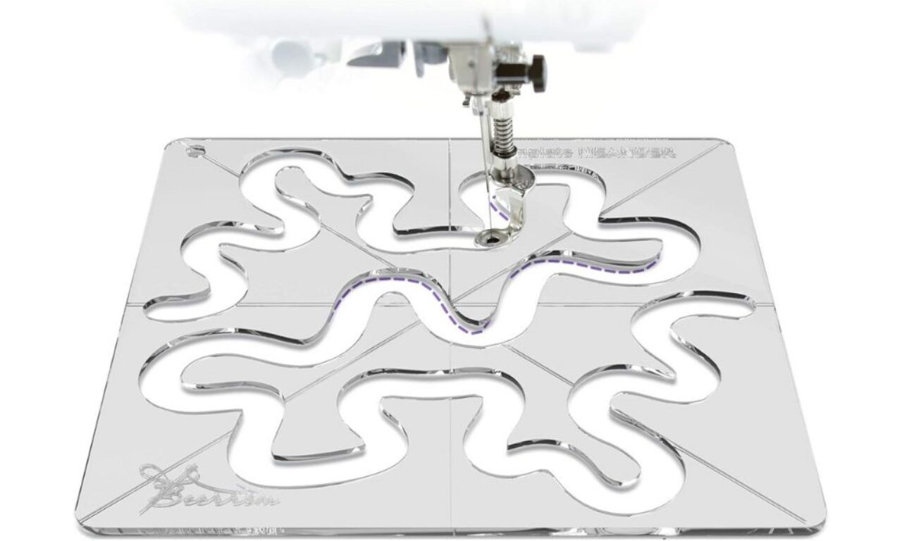 Quilting machine using a clear acrylic template for precise pattern stitching and fabric design
