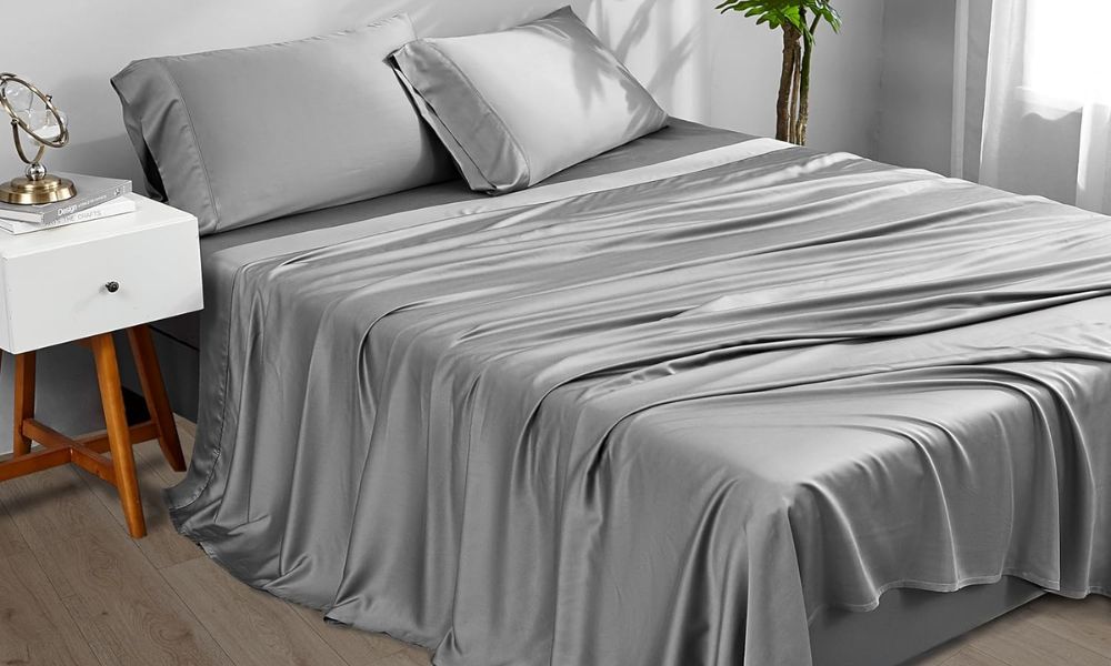 Luxurious gray silk bedding set with smooth sheets and pillows in a modern bedroom setting for comfort