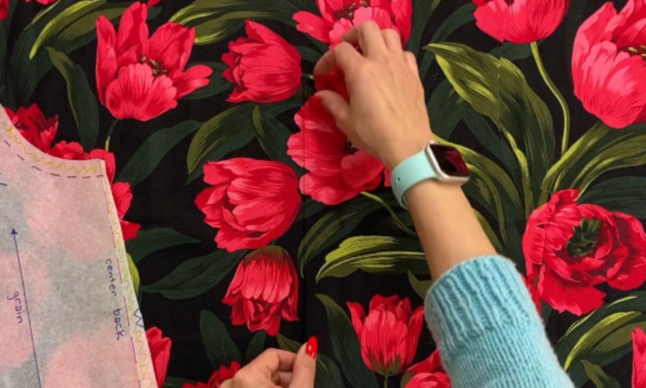 a piece of fabric with a bold red and green tulip floral print.
