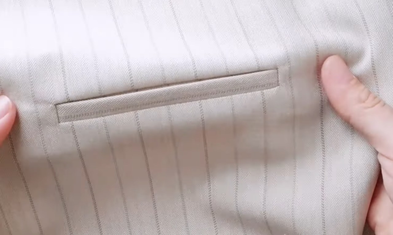 A perfectly finished welt pocket on pinstripe fabric