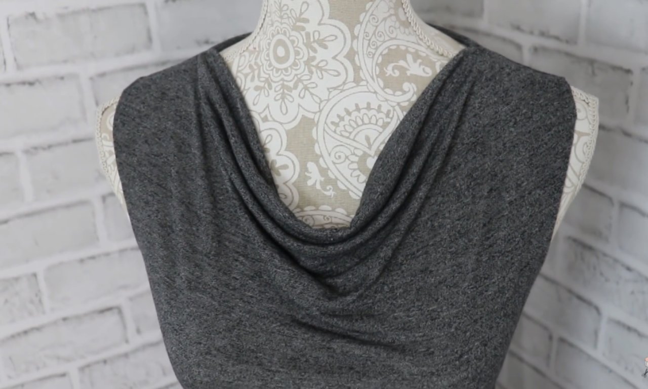 a dark gray, sleeveless cowl neck top on a patterned mannequin.