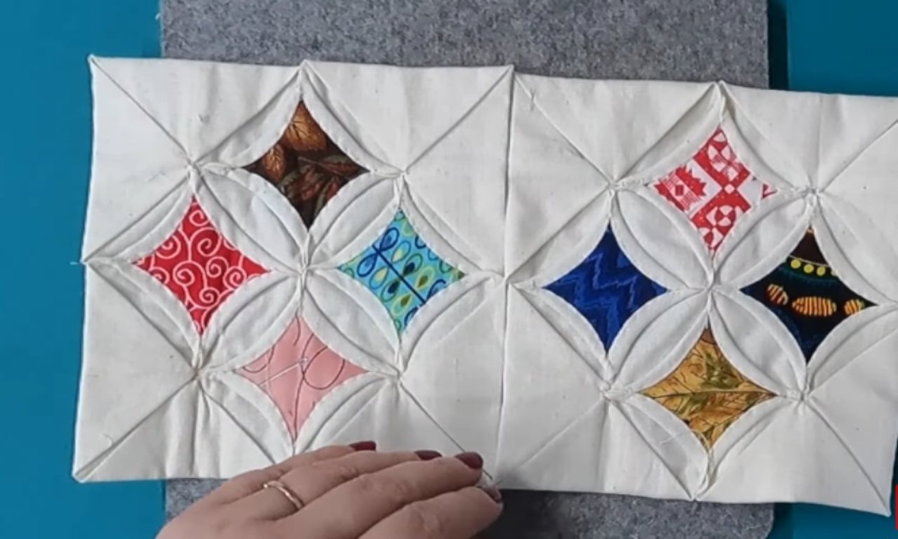 Two completed sections of a Cathedral Window quilt, each with four colorful windows, showing how the blocks are constructed.