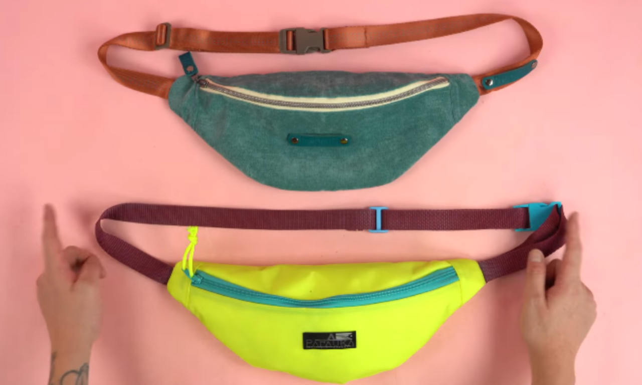 Two finished DIY fanny packs, one teal and one neon yellow, displayed on a pink background to show different style options.