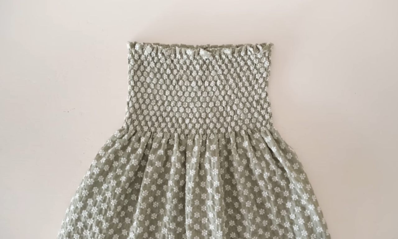 The dress without sleeves, highlighting the fully shirred bodice and gathered skirt.