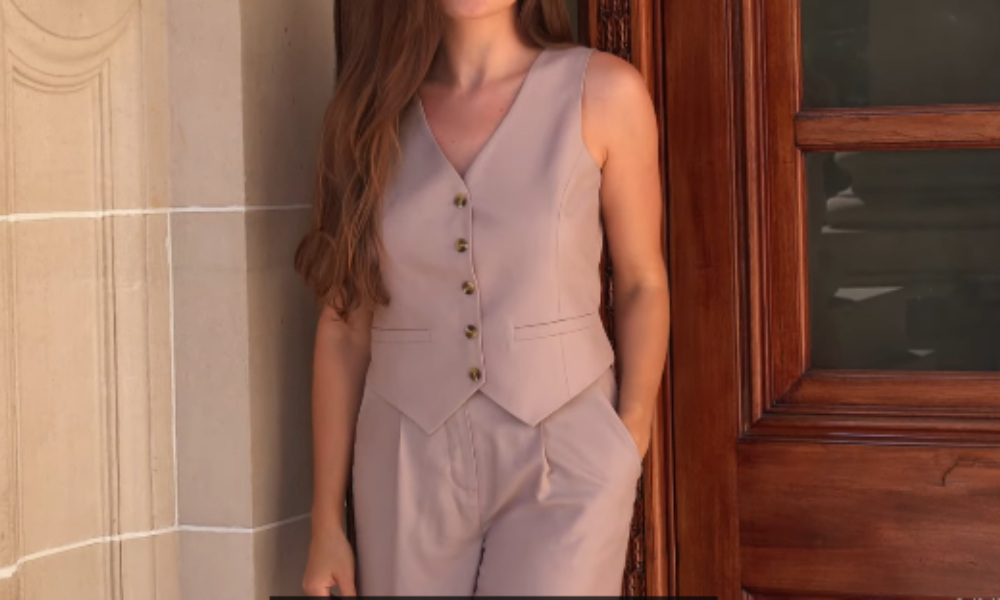 A woman models a perfectly fitted, light purple vest and matching trousers, showcasing a professional tailoring result.