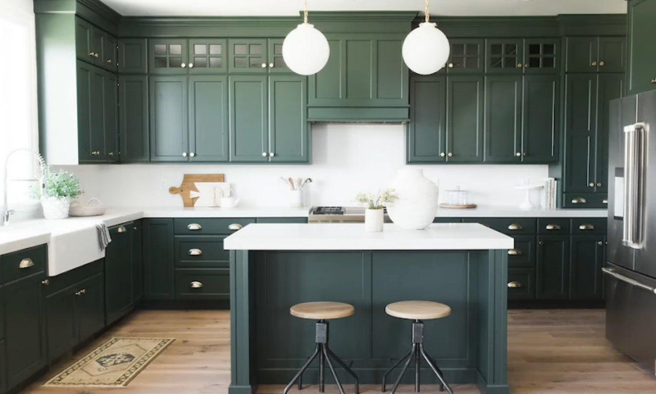 Kitchen with green cabinets and mixed gold and silver hardware