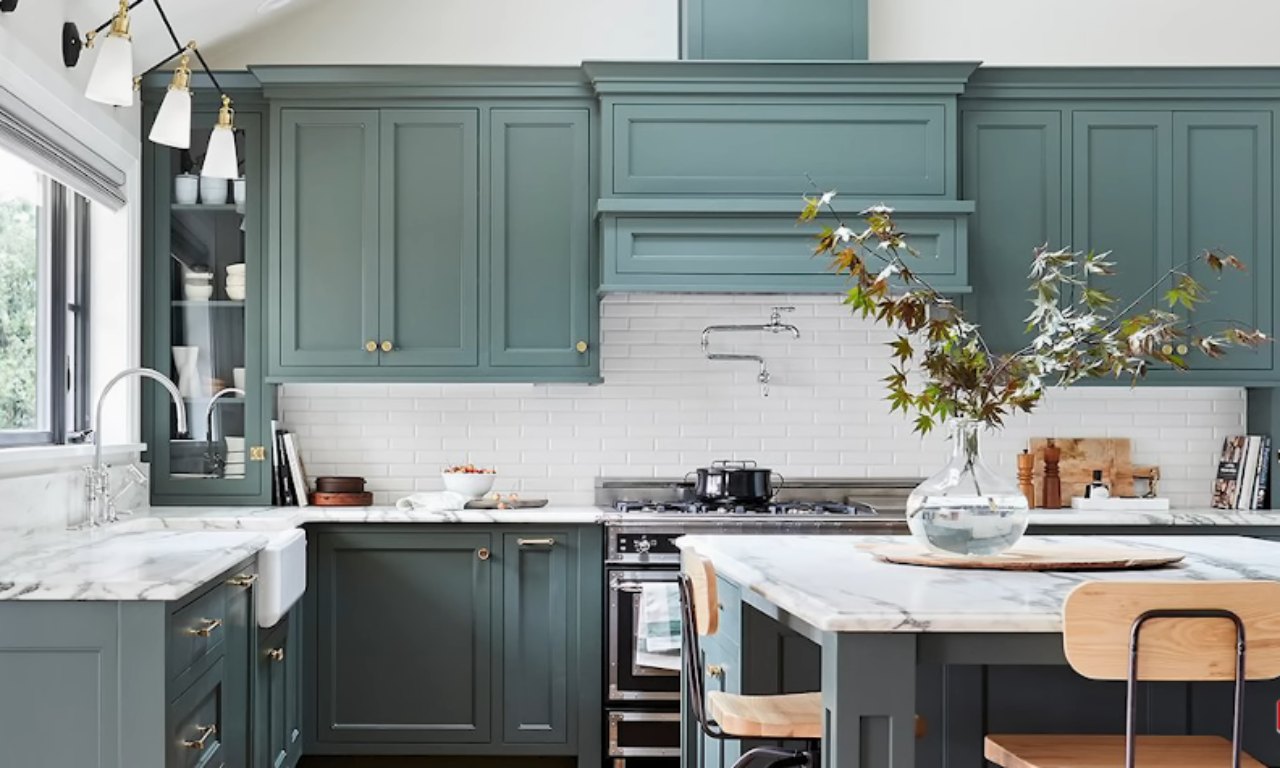 Kitchen with teal cabinets and arched details