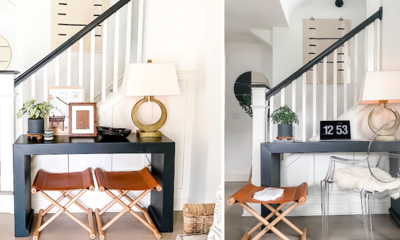 A stylish, modern entryway featuring a dark navy or black console table. On the table, there is a brass circular table lamp, a potted plant, and framed art. Beneath the table are two leather and light wood folding stools. The walls are white with a white staircase featuring black railings. The right side of the image shows an alternate styling with a clear acrylic chair and a laptop displaying the time 12:53.